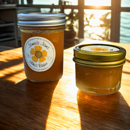 two jars of lilikoi butter passionfruit curd on a table by the ocean