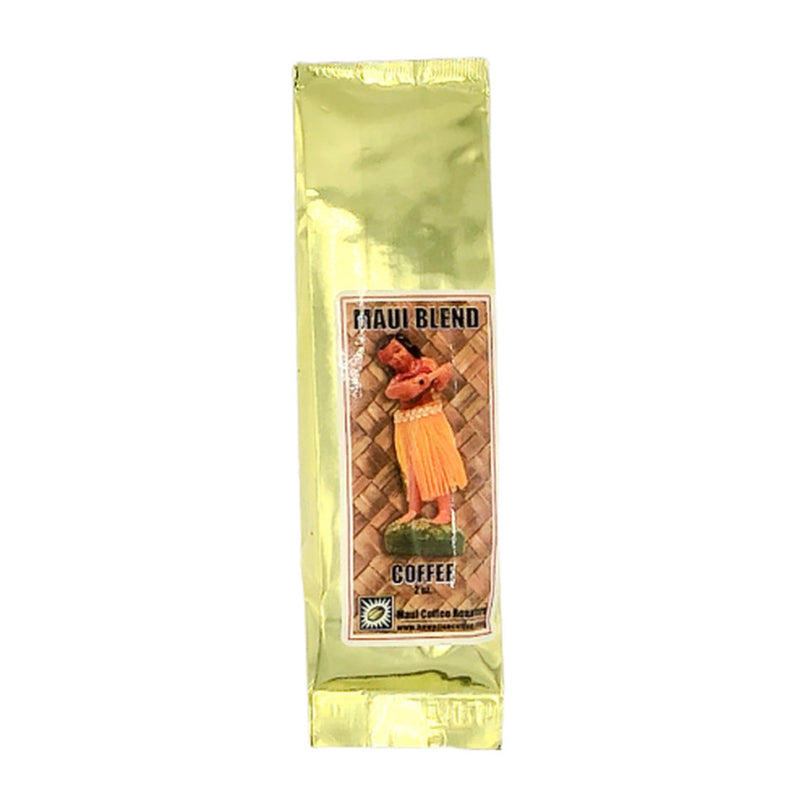 A package of Maui Blend coffee by Maui Coffee Roasters, featuring a gold and green wrapper with an image of a coffee plant and beans.