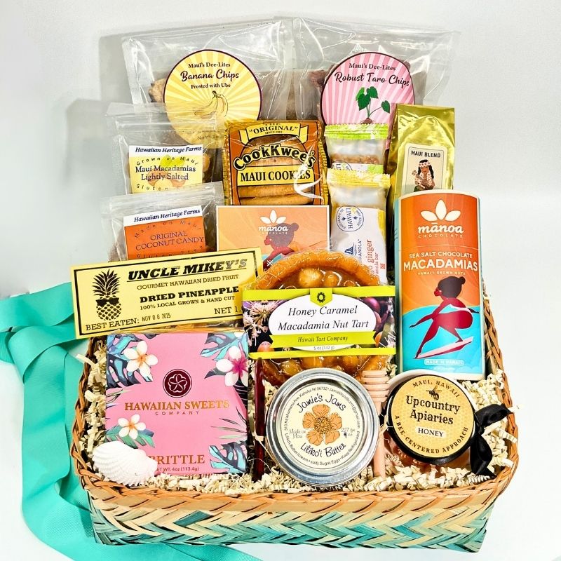 Gift basket with various products including snacks, candies, and a candle on a white background