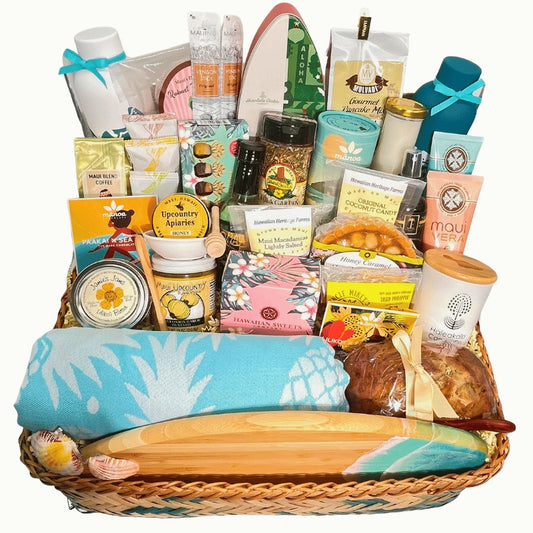 Gift basket with various items including a towel and snacks on a white background