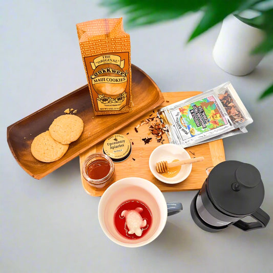 Tea set with cookies, honey, and a teabag on a wooden tray.