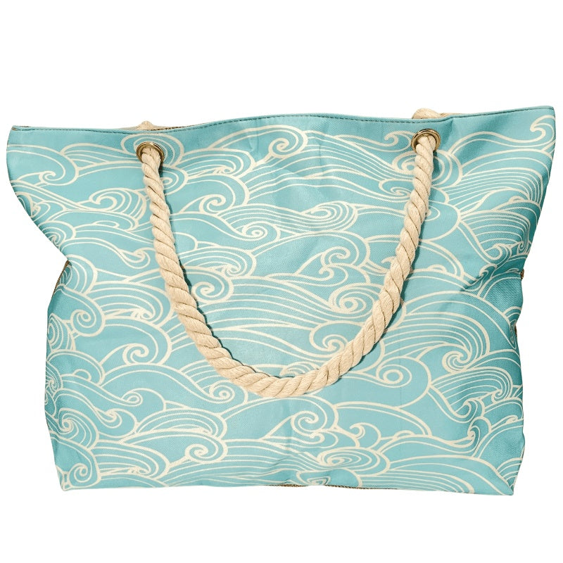 Blue tote bag with wave pattern and rope handles on a white background