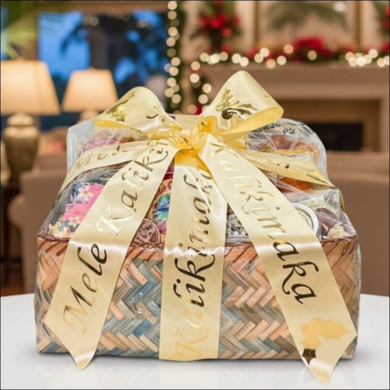 A bamboo basket filled with products created in Hawaii, including Upcountry Apiaries honey, Island Princess chocolate covered macadamia nuts, chips, etc. The gift basket is completed with an ivory bow with gold writing that says "Mele Kalikimaka"