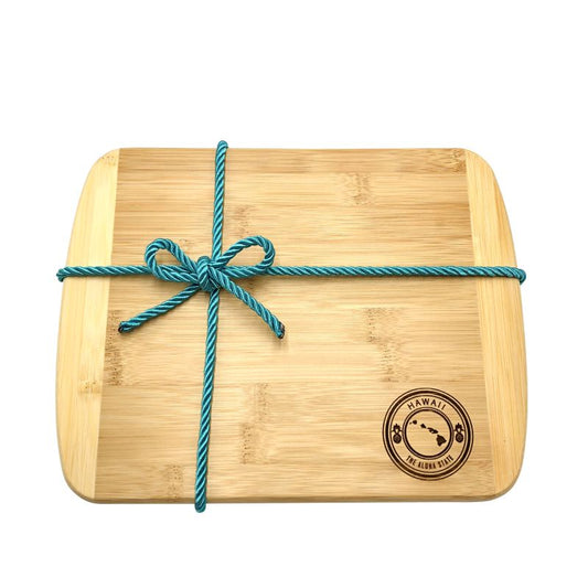 Bamboo cutting board with a blue string tied around it on a white background