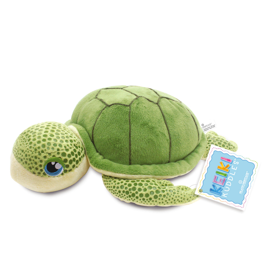 Green plush turtle toy with a visible brand tag on a white background