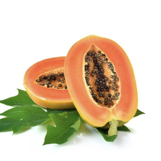 Halved papaya with seeds on a white background