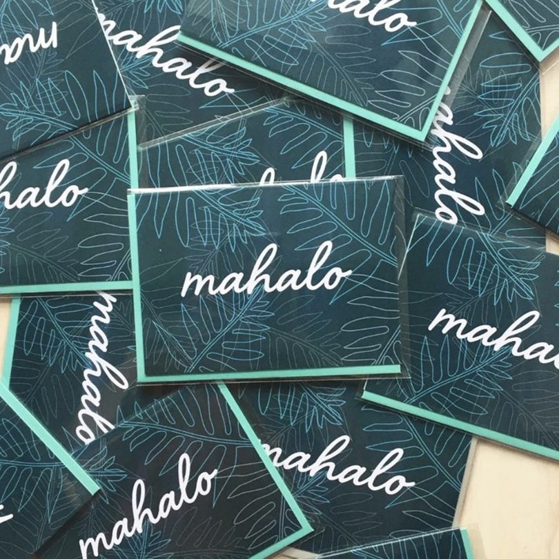 Stickers with 'mahalo' text on a leaf pattern background