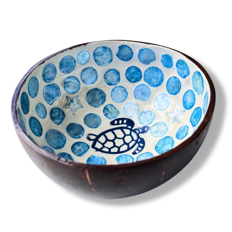 Ceramic bowl with blue dot pattern and turtle design on a white background