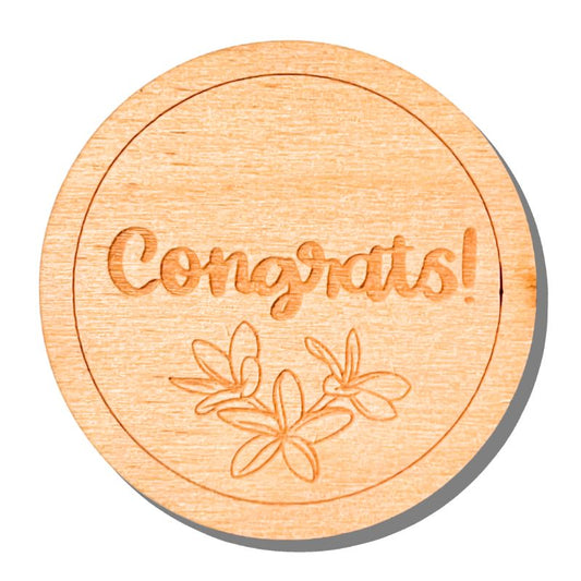 Wooden round coaster with 'Congrats!' and floral design on a white background