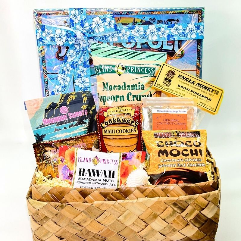 Gift basket with Hawaiian-themed snacks and a decorative box on a white background