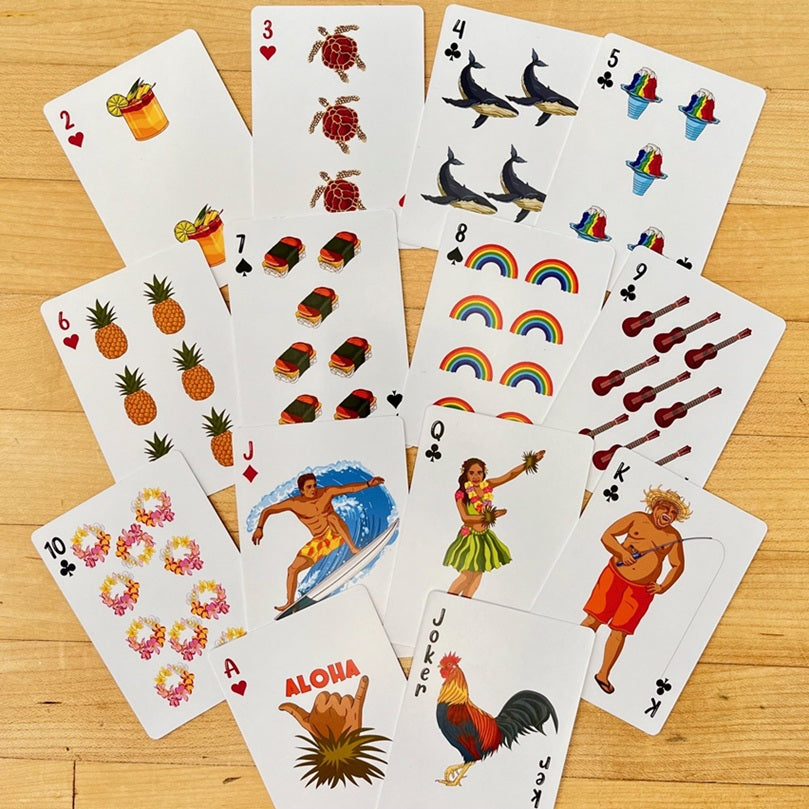 Set of playing cards with various designs on a wooden surface