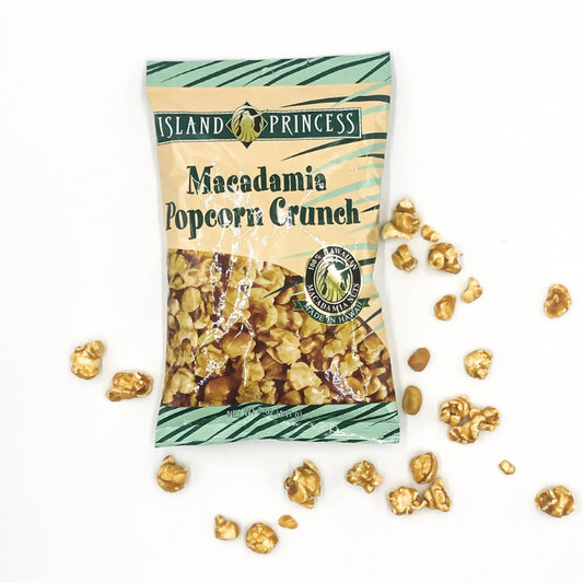 A package of Island Princess Macadamia Popcorn Crunch with caramel and nuts, with some popcorn and nuts scattered around the package.