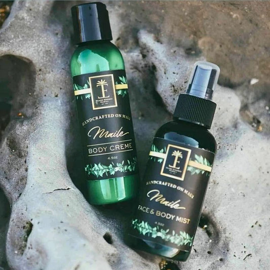 Two bottles of Maile body products on a textured surface
