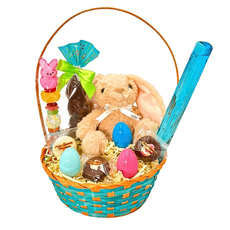 Easter basket with plush bunny, chocolate eggs, and candy on a white background