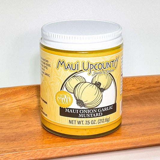 Jar of Maui Upcountry Maui Onion Garlic Mustard on a wooden surface with a white background
