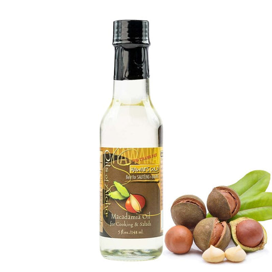 Bottle of macadamia oil with macadamia nuts on a white background
