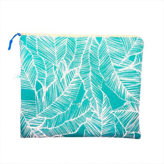 A plastic-lined wet/dry bag with a blue banana leaf pattern.