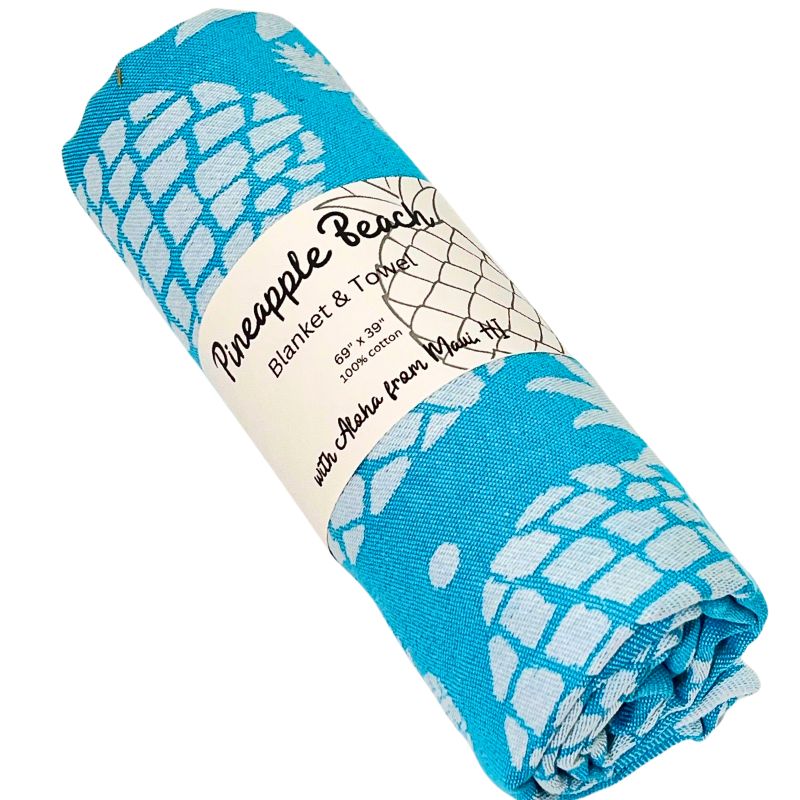 Roll of blue and white pineapple patterned blanket with label on a white background