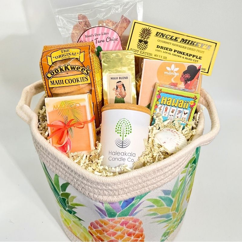 Gift basket with various items including cookies, a candle, and cards in a decorative basket.