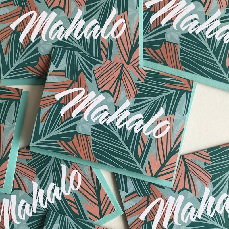 Stickers with tropical leaf pattern and 'Mahalo' text on a white background